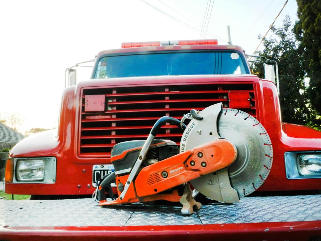Focused shot of a concrete saw on a red firetruck, showcasing emergency rescue tools.